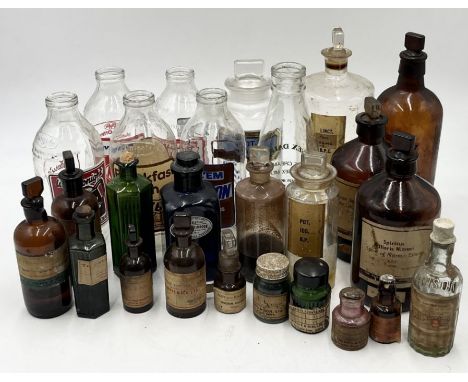 A collection of various vintage bottles including poison, medicines, milk bottles etc