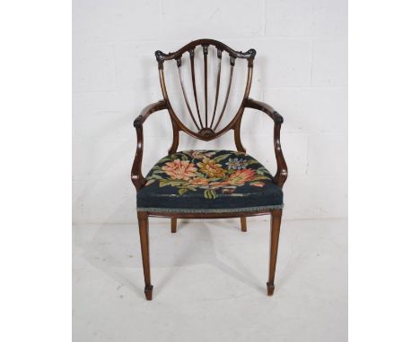 An Edwardian bedroom chair, with tapestry seat and carved detailing