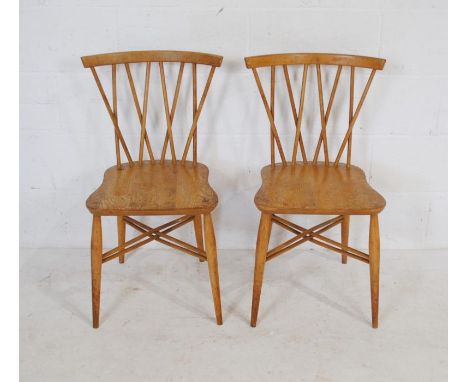 A pair of blonde Ercol lattice back (model 376) chairs