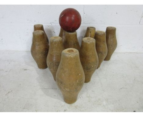 A vintage set of wooden skittles along with a rubber skittle ball