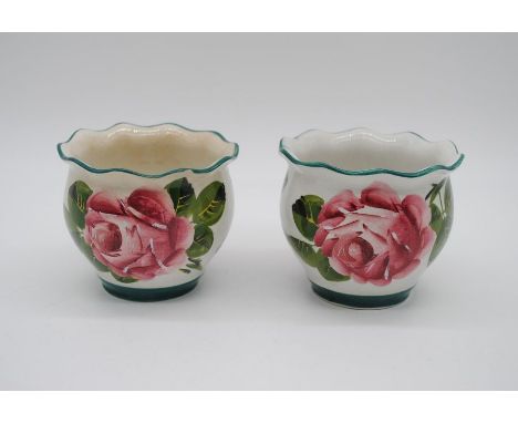 A near pair of Wemyss ware pots, one A/F 
