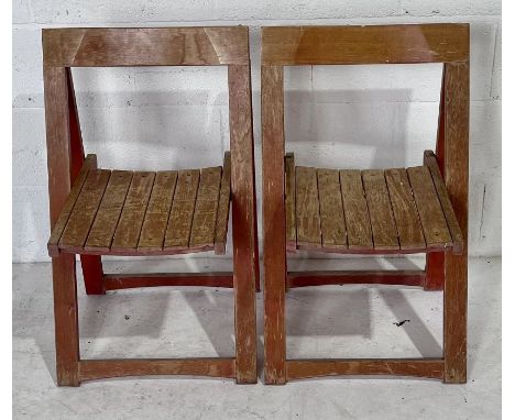A pair of folding vintage wooden chairs.