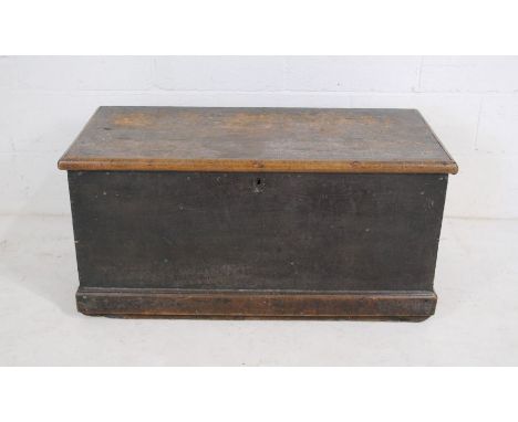 An antique pine trunk with rope handles.