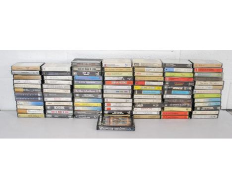 A collection of cassette tapes, including Pink Floyd, Led Zeppelin, The Beatles, The Rolling Stones, Bob Dylan, David Bowie, 