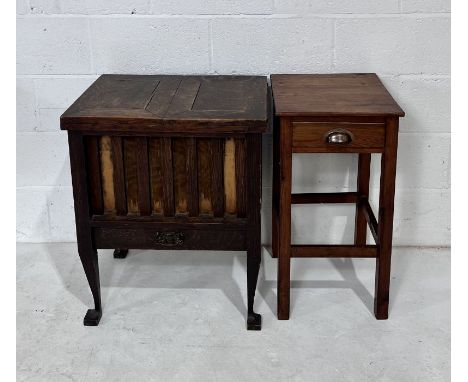 An vintage oak sewing cabinet along with a small side table.