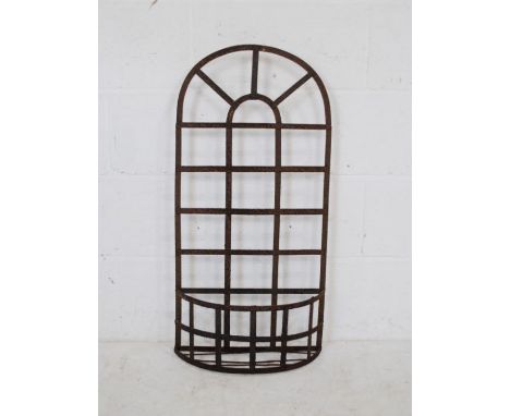 A weathered metal bow fronted wall hanging shelf - length 40cm, height 81cm