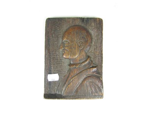 A 16th / 17th Century carved oak panel bearing the bass relief profile portrait of a gentleman, 19 x 13 cm  