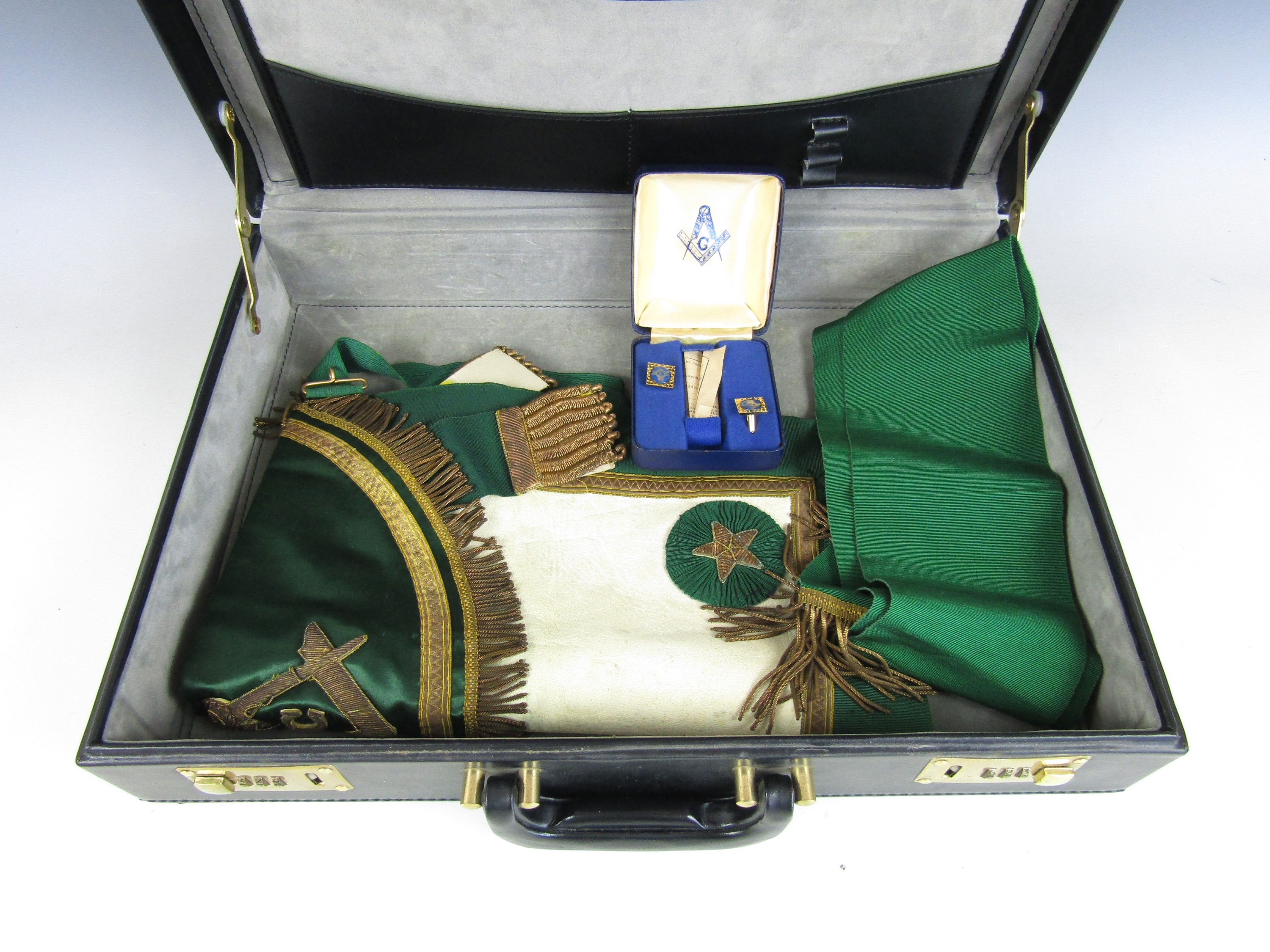 A vintage briefcase containing Masonic regalia including a cased set of