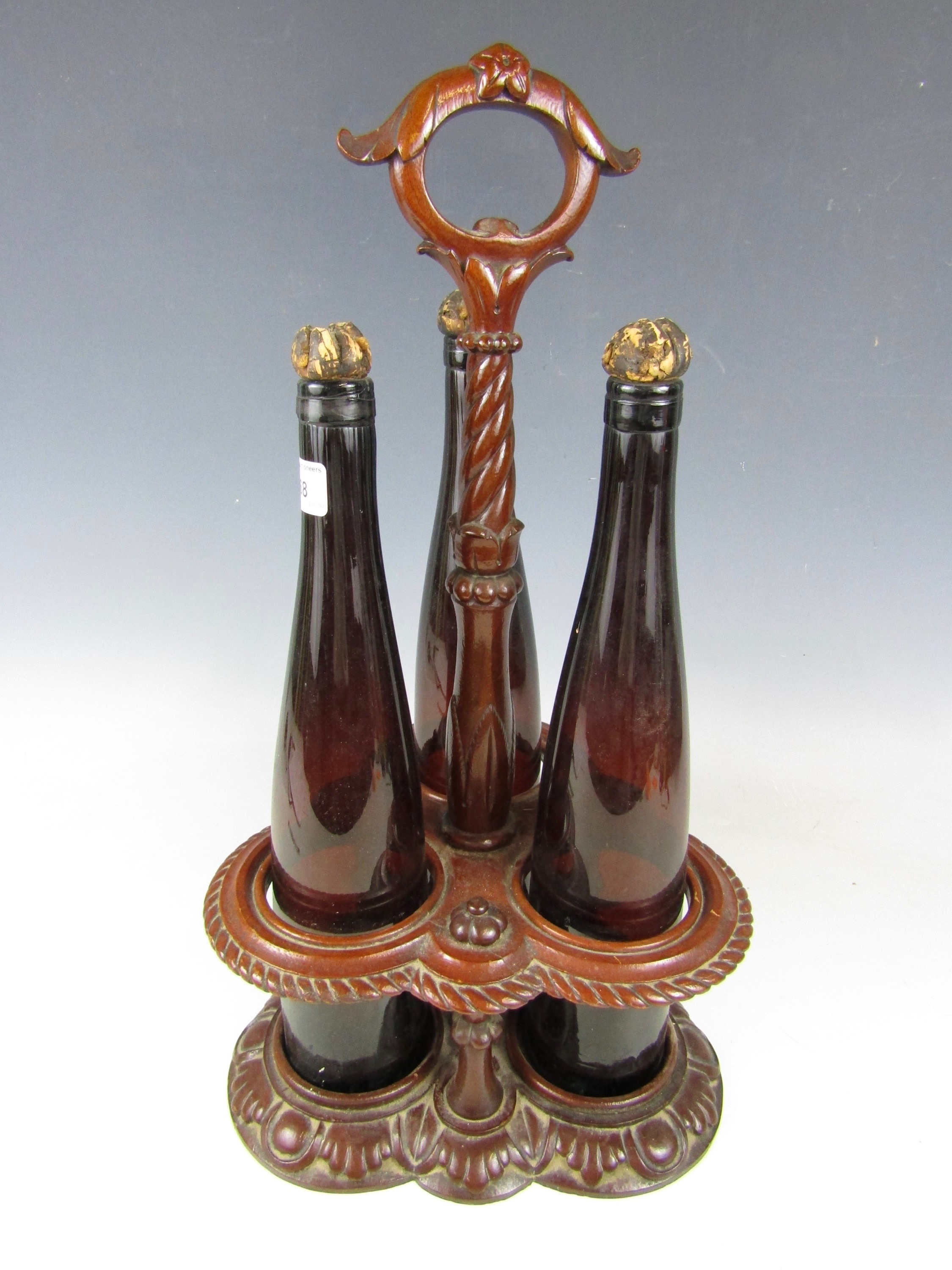 A Victorian carved mahogany decanter stand with bottles