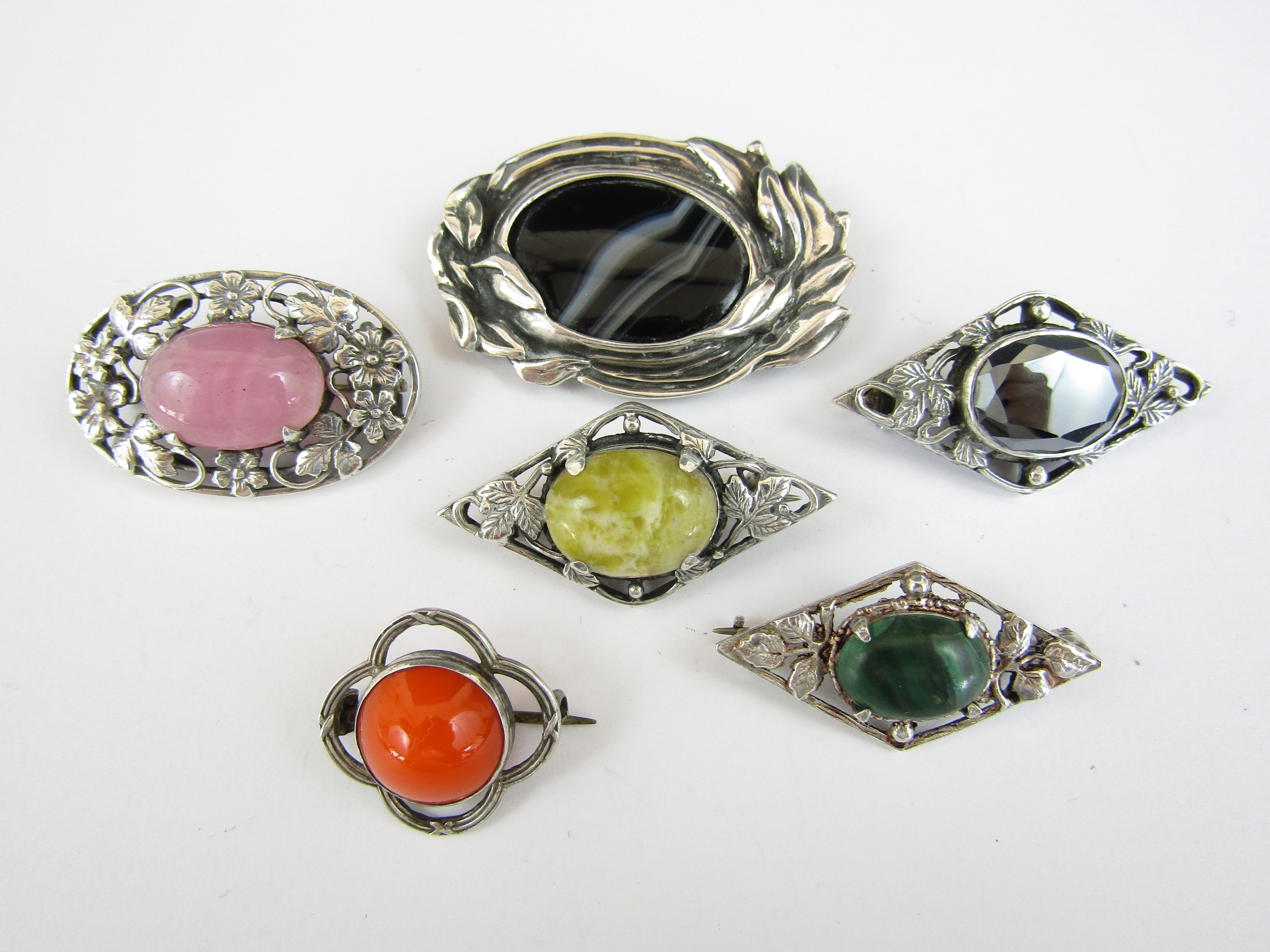 Vintage Arts and Crafts style white metal brooches, each centrally set