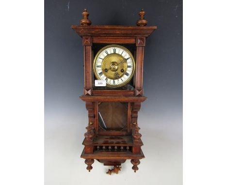 An oak wall clock in architectural case