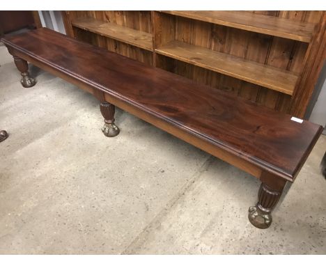 A reproduction mahogany low window seat / bench