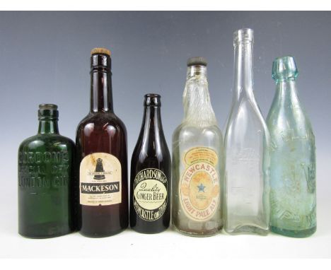 Six vintage glass bottles including Mackeson Stout, Newcastle Light Ale and Richardson's Newcastle Ginger Beer