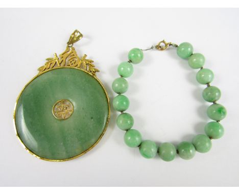 A jade bead bracelet with yellow metal clasp, together with a similar pendant with gold plated mounts