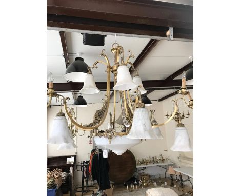 A large multi-branch brass pendant ceiling light with marbled glass shades