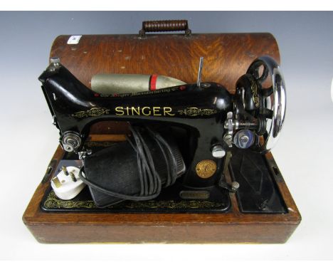 An early 20th Century Singer sewing machine, with original instruction manual