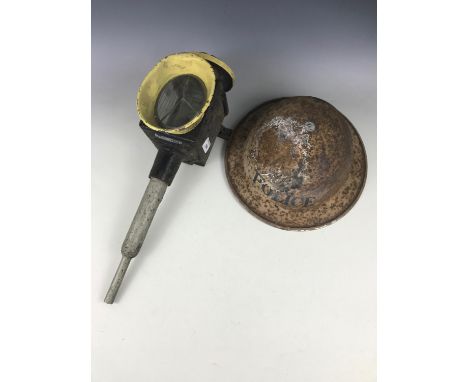A carriage lamp together with a Second World War police helmet