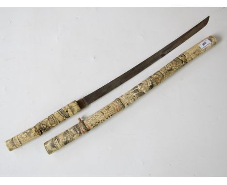 An early 20th Century Japanese sword with carved bone mounts and scabbard