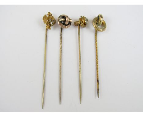 Four late 19th / early 20th Century rolled gold stick pins, one with Art Nouveau terminal set with three paste stones 