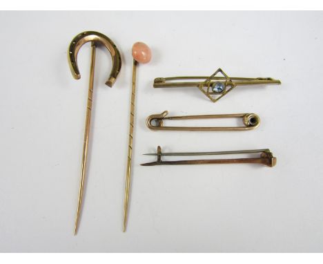 An early 20th Century yellow metal brooch, stamped 9ct, together with a yellow metal stick pin with horseshoe terminal, a sti