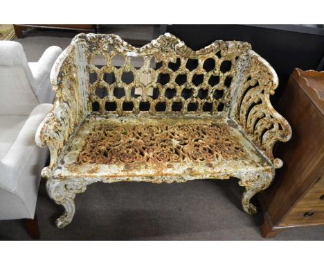 A small Victorian cast iron garden bench with pierced decoration, the back formed in a horseshoe type design, the seat and ar