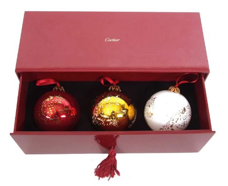 Cartier: a set of three Cartier glass Christmas baubles, in red, white and gold glass with Cartier leopard to each, with gilt