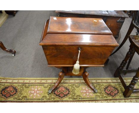A Georgian mahogany sarcophogus formed teapoy with hinged lid opening to a fitted interior raised on a square column with fou