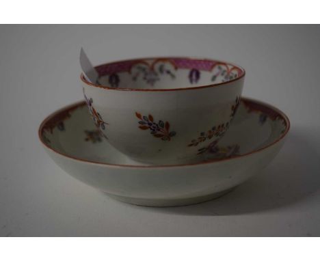 An 18th Century Worcester tea bowl and saucer with famille rose type design