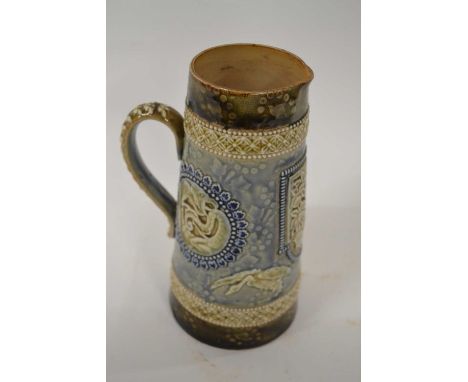 A Doulton Lambeth jug with various applied designs of dragons and fish, monogram for MG to base, 20cm high
