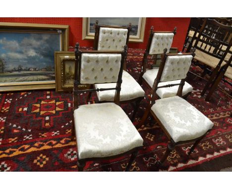A set of four late 19th Century mahogany framed dining chairs with button upholstered backs and seats, raised on fluted legs