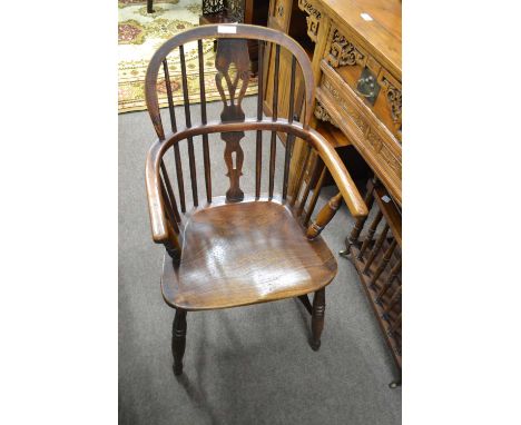 A 19th Century elm seated and stick back Windsor chair with turned legs and H formed stretcher, 87cm high