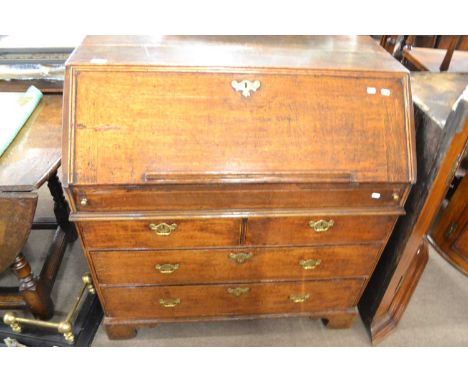 An early Georgian oak bureau with full front opening to a step and well interior over a body with two short and two long draw