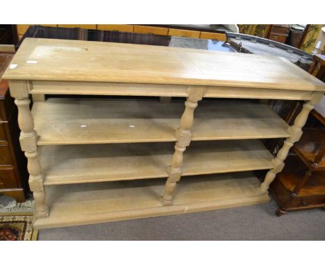 A contemporary light oak shelf unit with baluster turned supports, 60cm wide