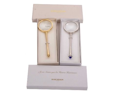 Two Boucheron magnifiers, one in white metal with blue glass finial, branded 'Boucheron Paris' to handle, 13cm long, in brand