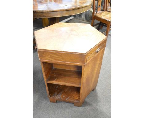 An Art Deco style walnut and birdseye maple veneered hexagonal centre table/shelf unit with three pull out slides, 63cm high,