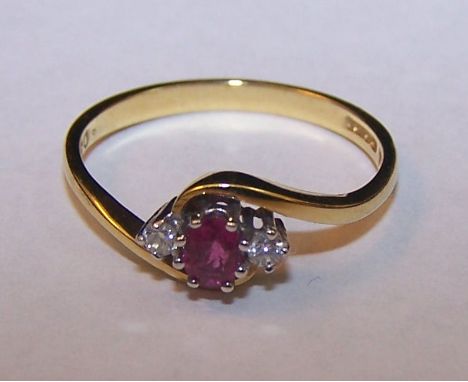 An 18ct gold ruby and diamond three stone Crossover Ring.