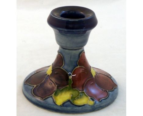 A Walter Moorcroft Candlestick decorated with the blue Clematis pattern and with Moorcroft Museum label, 3 1/2" (9cms) high, 