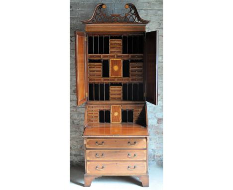 A Sheraton design mahogany Bureau Cabinet inlaid with satinwood banding and oval paterae, the upper section with a fret carve