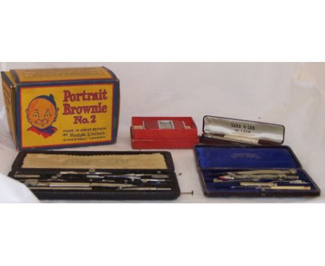 A set of Riefler Drawing Instruments in case, one other set, a Kodak Brownie no. 2 box camera in original case and two other 