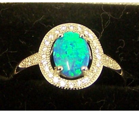 A silver Dress Ring set with a blue opal and cubic zirconia.