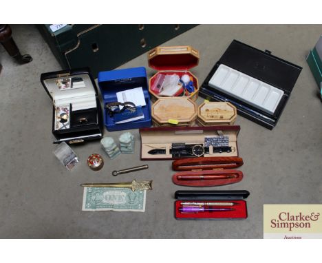 A box containing various watches, pens, letter opener, jade figures etc.
