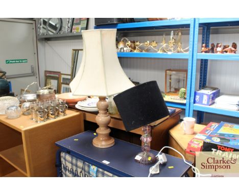 An amethyst coloured glass table lamp together with a pottery table lamp and shade