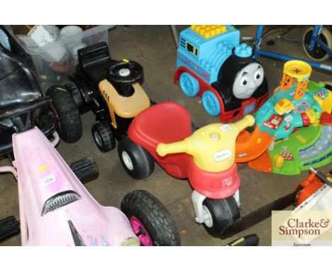 A Little Tikes trike and a pull along tractor