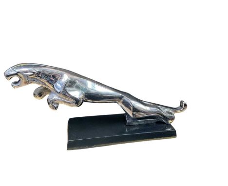 Freestanding metal desk model of a leaping Jaguar, 30cm in overall length.