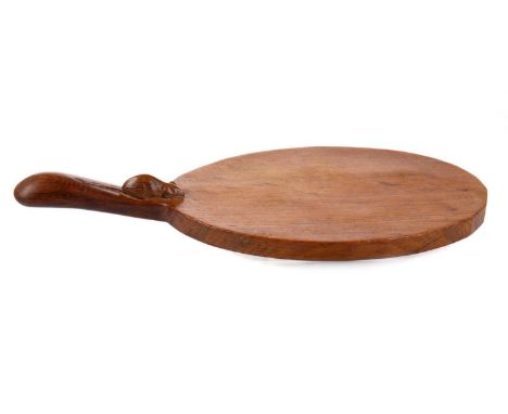 ROBERT 'MOUSEMAN' THOMPSON OF KILBURN,  ADZED OAK CHEESEBOARD of oval form, with a carved mouse signature on the base of the 