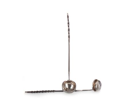 TWO GEORGIAN TODDY LADLES, each with coin set white metal bowl and twist baleen handle, the first with initialled bowl inset 