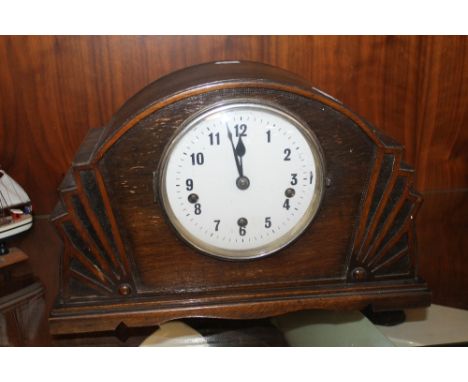 A WESTMINSTER CHIME OAK MANTEL CLOCK WITH KEY