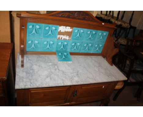 A MARBLE TOPPED TILE BACKED WASH STAND