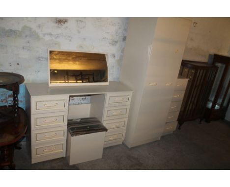 A BEDROOM SUITE CONSISTING OF A WARDROBE, CHEST OF DRAWERS, DRESSING TABLE AND A STOOL