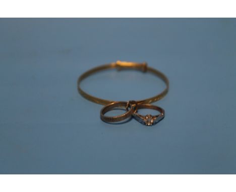 A CHILD'S 9 CT GOLD BANGLE TOGETHER WITH A 9 CT DIAMOND RING AND A BAND